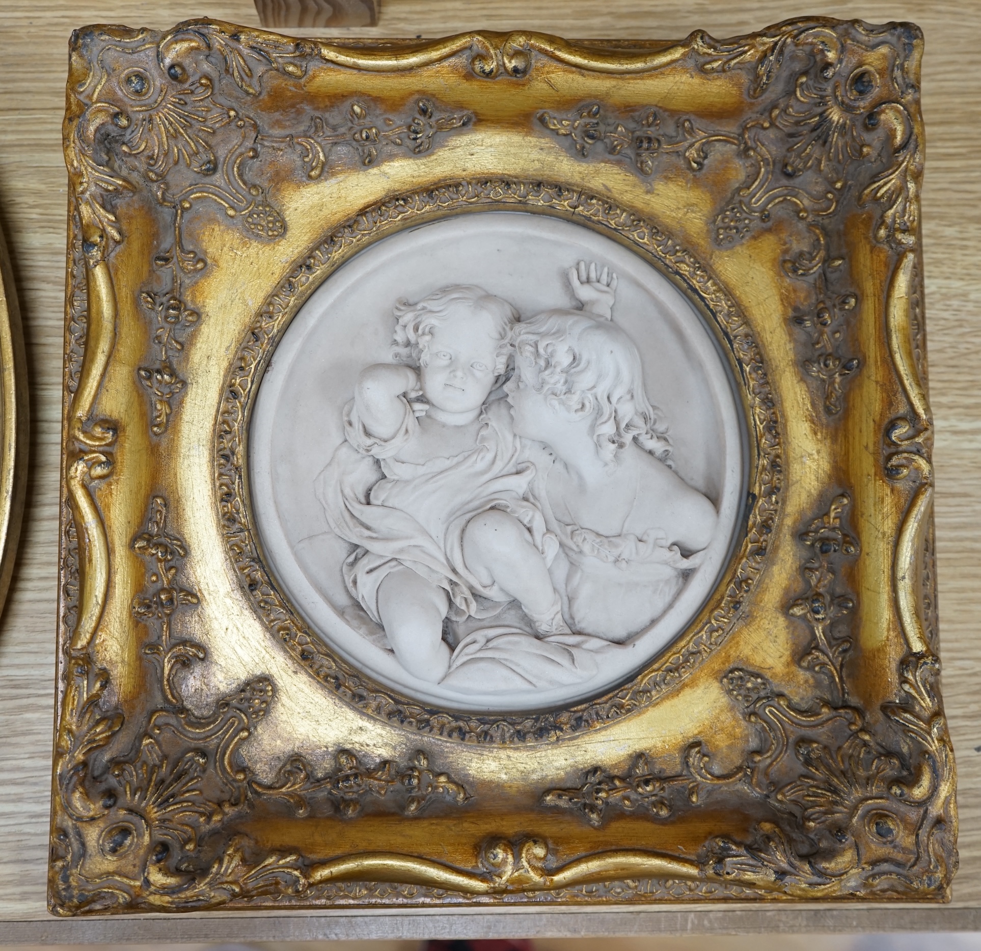 A pair of framed faux marble plaques and a similar oval plaque. Condition - good